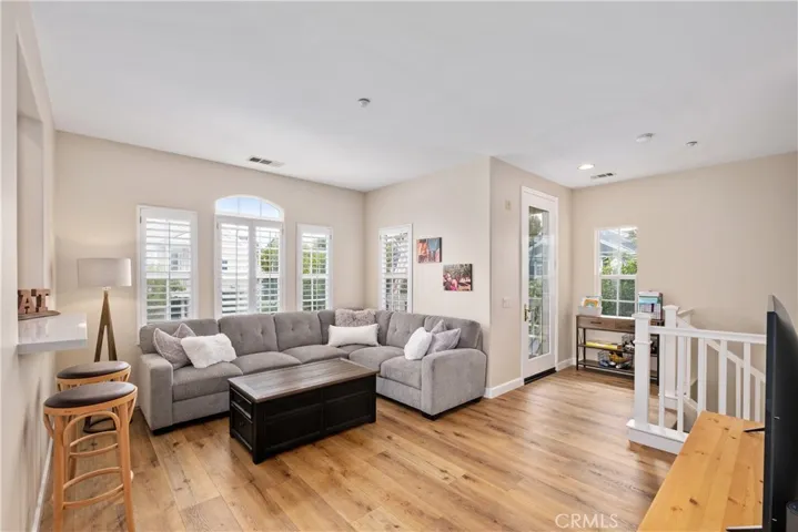 The living room is cozy and has an abundance of light.  There is a covered balcony just outside the living room.