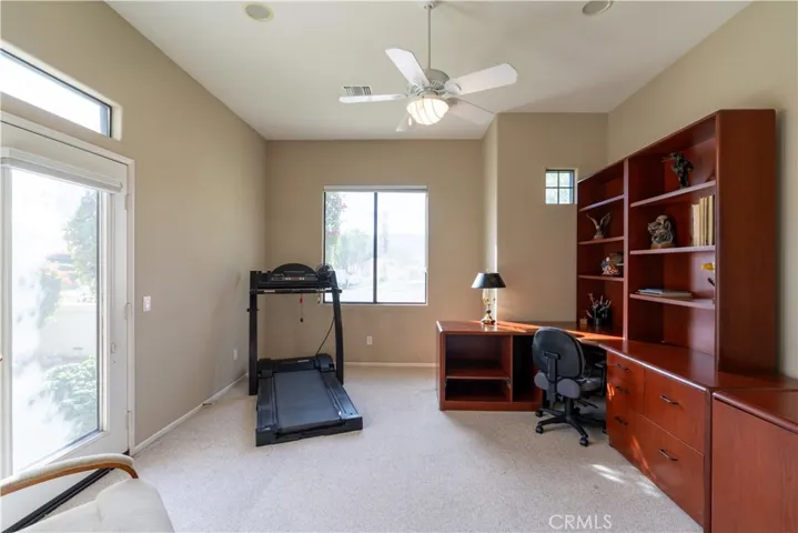 As you walk through the master bathroom, you come to an office/den on the front of the home