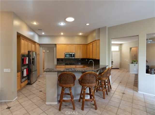 Full length breakfast bar that is between the kitchen and the family roo
