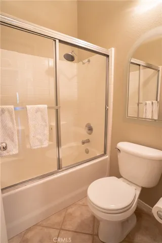The water closet and shower tub in the front bathroom