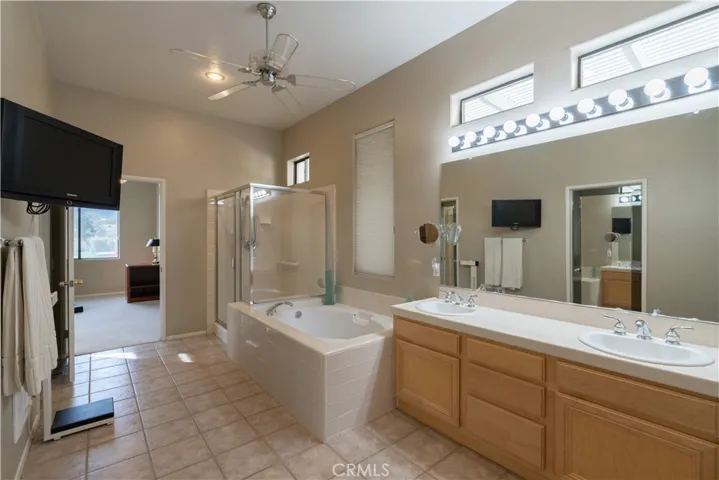 The large master bathroom features a double sink and a separate shower and tub