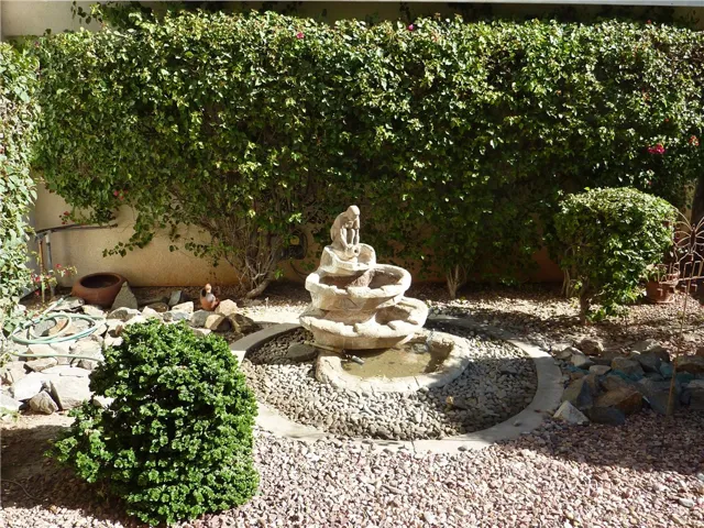 As you enter the home through the front double doors, there's a small court yard with a fountain. On the opposite side of the fountain is the den off the master suite.