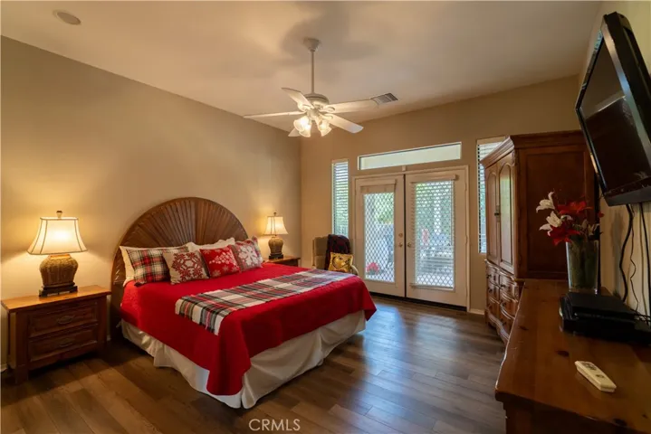 The master suite features a large bedroom with double doors that open up to the back patio and pool