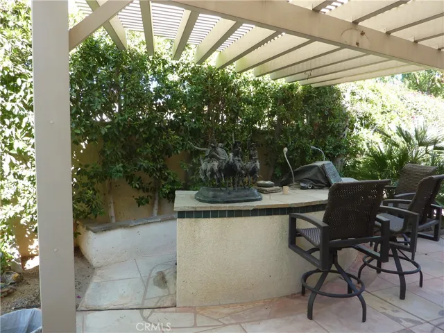 The built-in bar-b-que has bar seating in front of it and easy access to the cooking side.