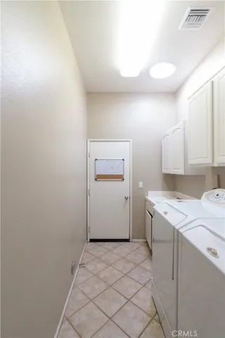 The laundry area is located between the garage and the kitchen and features a built in wash basin