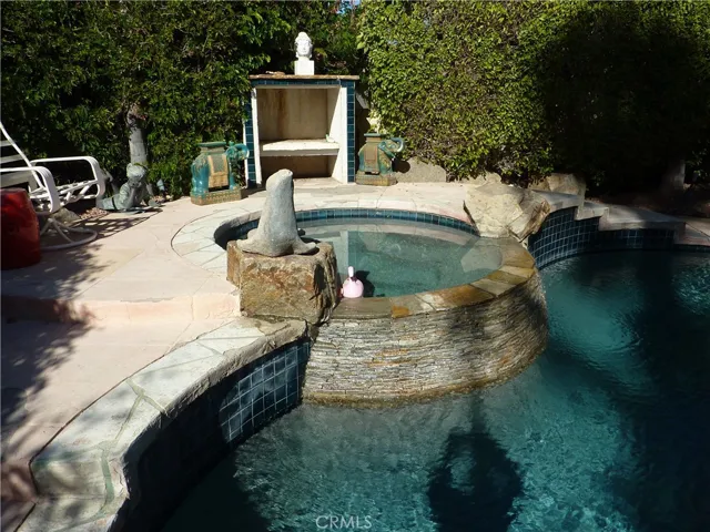 The spa flows into the pool and provides a private setting for enjoying the outdoors year round, especially at night.