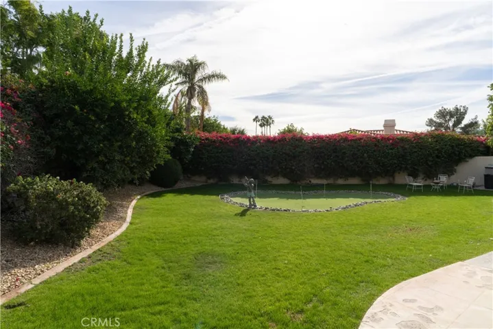The right side of the home features a built in putting green and a nice grassy area for the children and/or pets.