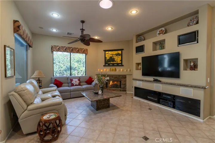 The big screen tv in the custom built wall stays with the home, as do the other 2 small tv's