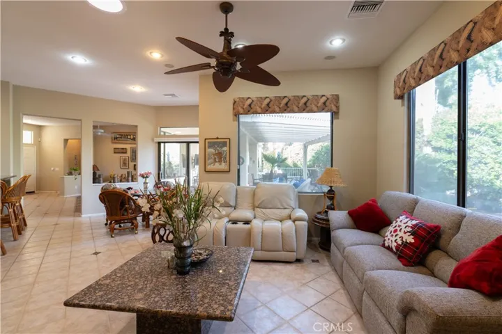 The living area of the home has an open floor plan to the dining nook, the living room, and the front door