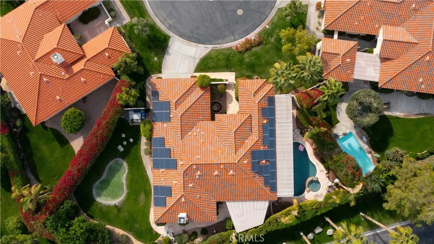 From the air, it's easy to see the swimming pool and hot tub on one side of the home and the putting green and grass area on the other side