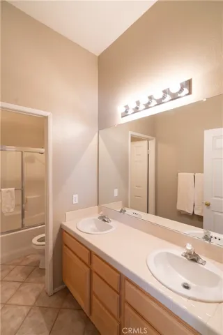 The full bath for the front two bedrooms has a double sink and a private water closet area with the shower and tub