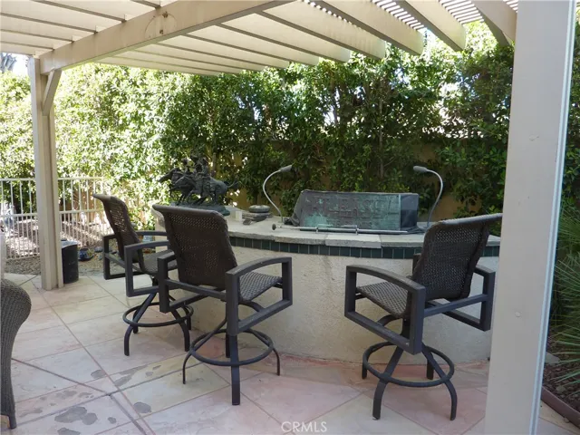 Just outside the family room in the middle of the back yard is a covered built in gas bar-b-que.