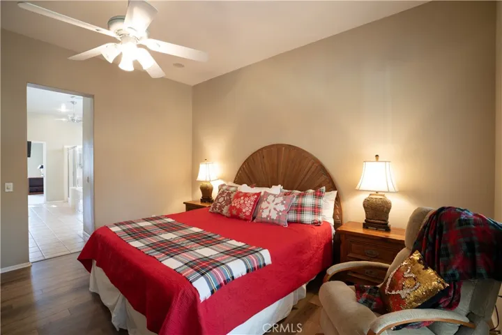 There's a ceiling fan in the master bedroom and the door leads to the master bathroom