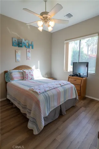 This is the middle bedroom of the home. It has a large window that overlooks that grass area and the putting green