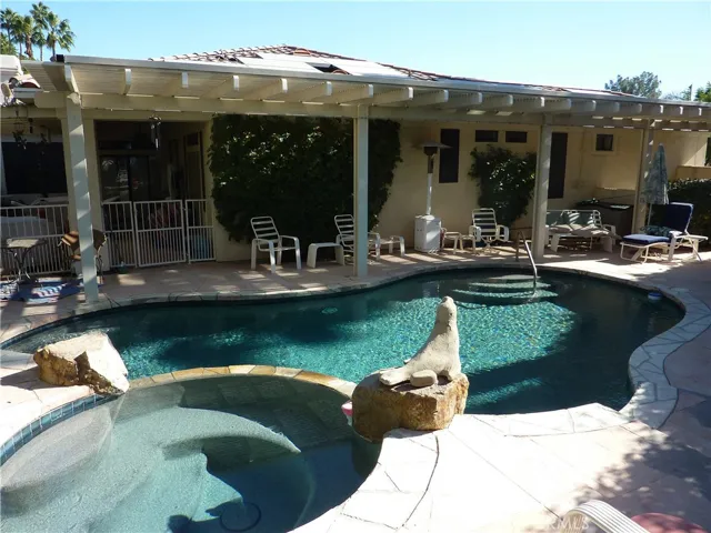 From the spa, you can see the covered patio area and the fully fenced in pool area. From the pool, you have easy access to the covered bar-b-que and patio area, and the master bedroom and family room.