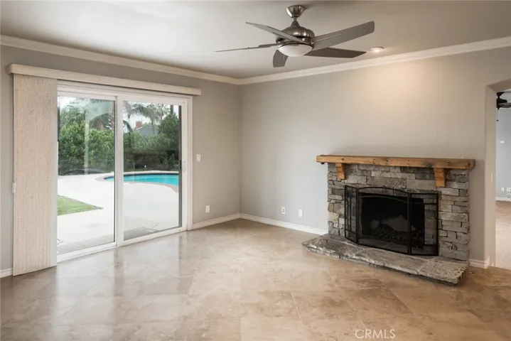 Fireplace in living room, pool backyard views.