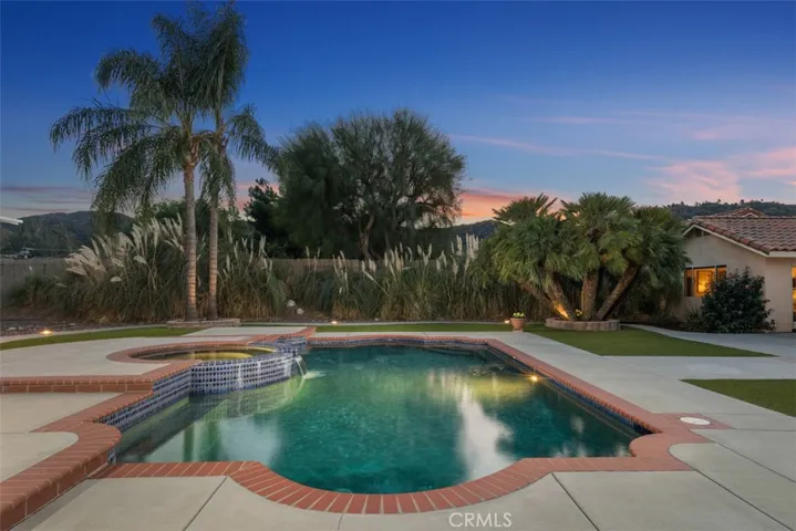 Relax poolside to the soothing rhythm of the waterfall feature!