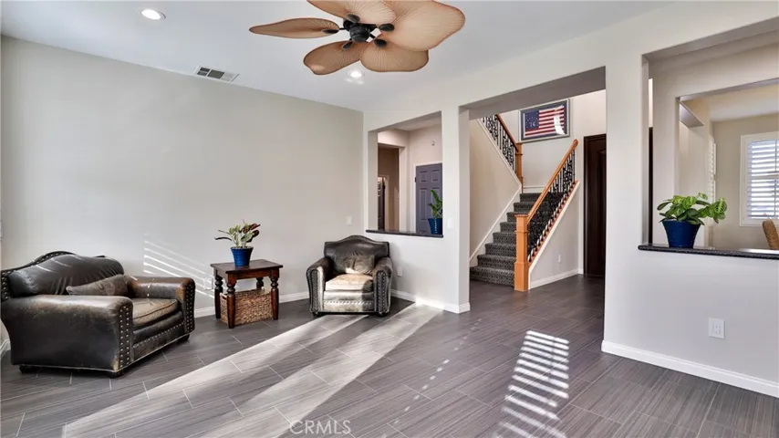 The open flowing floorplan shows how the entry leads to the formal living space with the adjacent formal dining room and staircase leading to the second level.