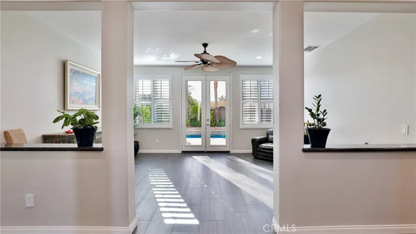 The formal living room has double French doors which lead to your private resort.