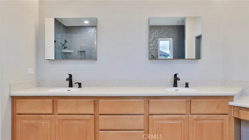 Double sinks in the primary bathroom.  The Phister faucets are in the popular mocha finish.