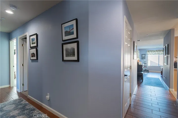 Hallway to the right is living room and to the left is guest bedrooms and guest bath