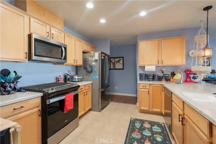 Kitchen view with upgraded appliances, soft close cabinets, solid surface countertops