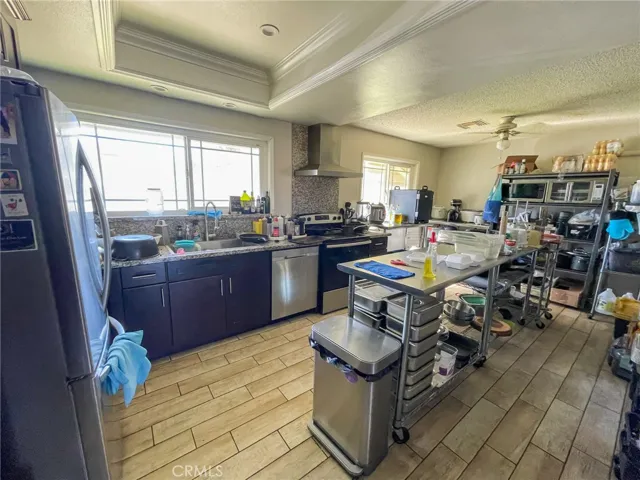 Please note the kitchen is open and spacious. the current tenant makes food and the serving tables and items are not included in sale.