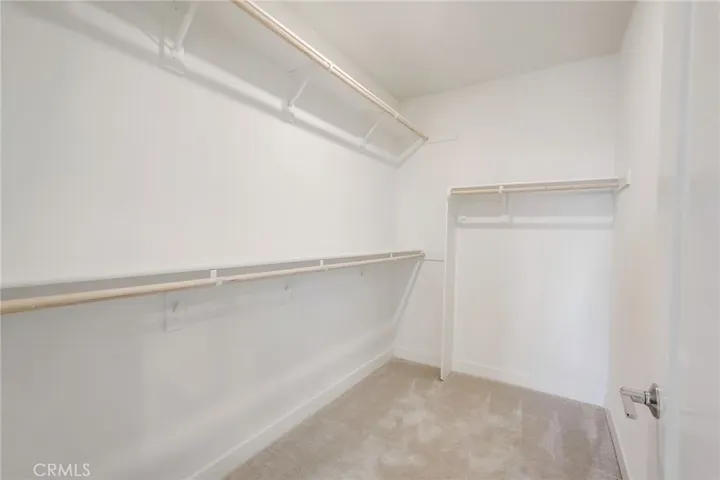 A large walk in closet is a must have in this retreat style primary bedroom space.