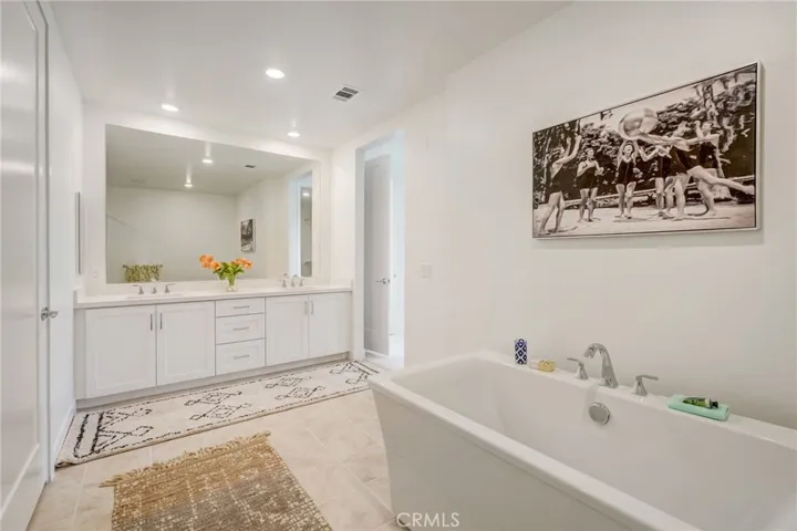 The primary en suite spa-like bath has double sinks and this relaxing soaking tub.