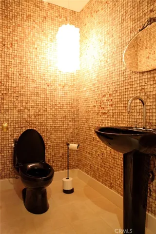 Powder room on Game room level.  coconut shell walls