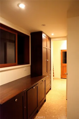Separate laundry room Lots of teak cabinet space, Wall iron, washer/dryer. Exit door  to outside for ease in catering.