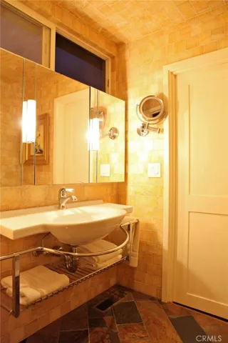 Bath that serves the upper level.  Walk in quartz shower, full glass doors.