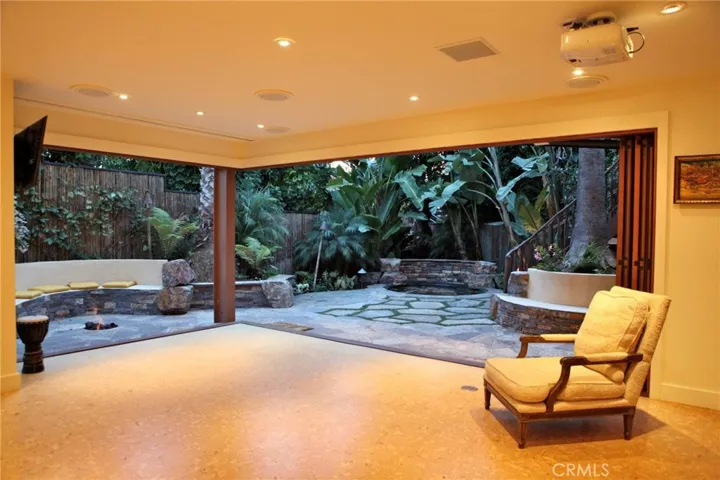 ooohhh  What a fun house.  Looking from the game room to black bottom jacuzzi.  Wide open windows. Great room for all these ZOOM meetings.  This room has a full wet bar, TVs powder room and laundry.  Master Suite also located here.