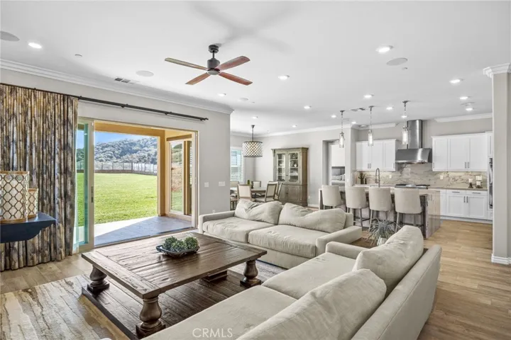 Family room with custom drapery adjacent to the CA Room for indoor/outdoor entertaining.