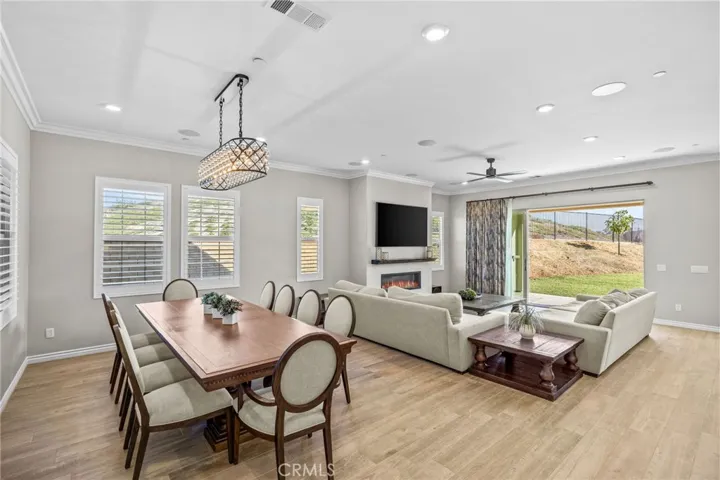 Family room and formal dining area with highly upgraded chandelier and elegant Bedrosians tile flooring.