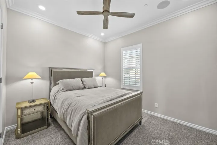 Bedroom #3 Newer carpet, ceiling fan, custom shutters, crown molding, freshly painted, commercial grade safe in closet