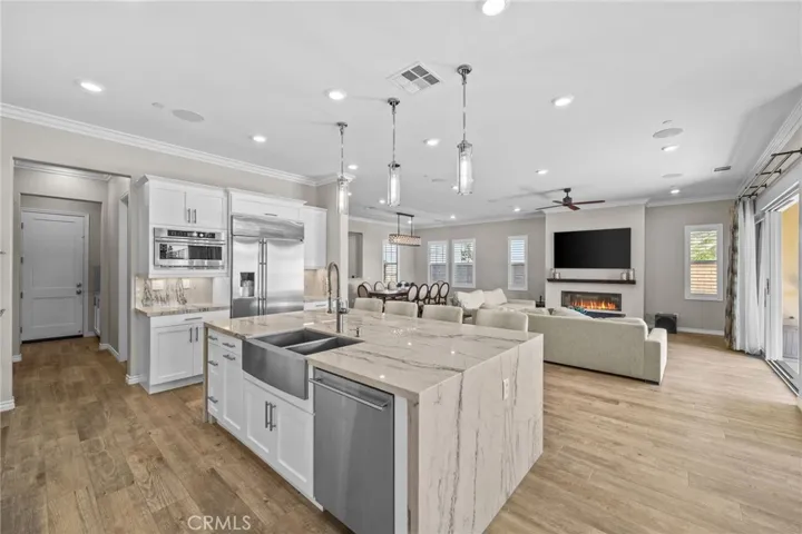 Soft-close cabinetry, farm sink, and walk-in pantry with full wood shelving. Entertaining at its finest.