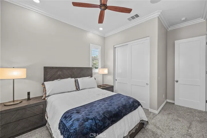 Bedroom #2 Newer carpet, ceiling fan, custom shutters, crown molding, freshly painted, commercial grade safe in closet