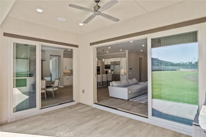 Win-Dor stacked panoramic glass doors open the home to indoor/outdoor living