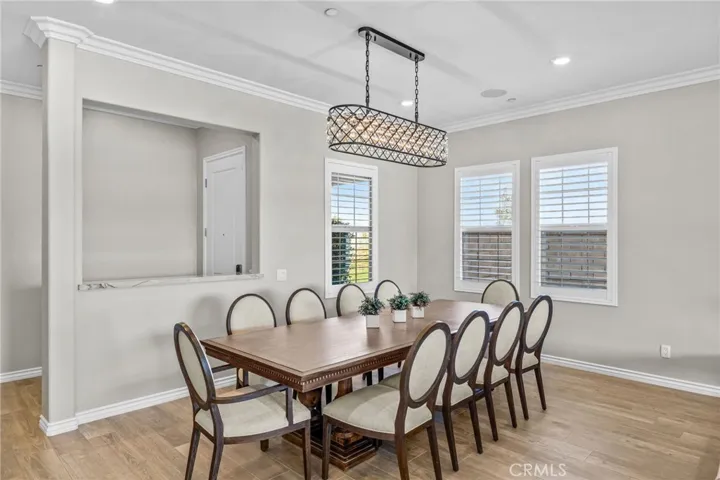 Another angle of the formal dining area with upgraded chandelier, including entryway with quartzite counter ledge.