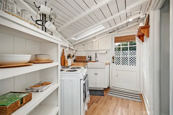 The kitchenette has a door leading outside to the side patio.