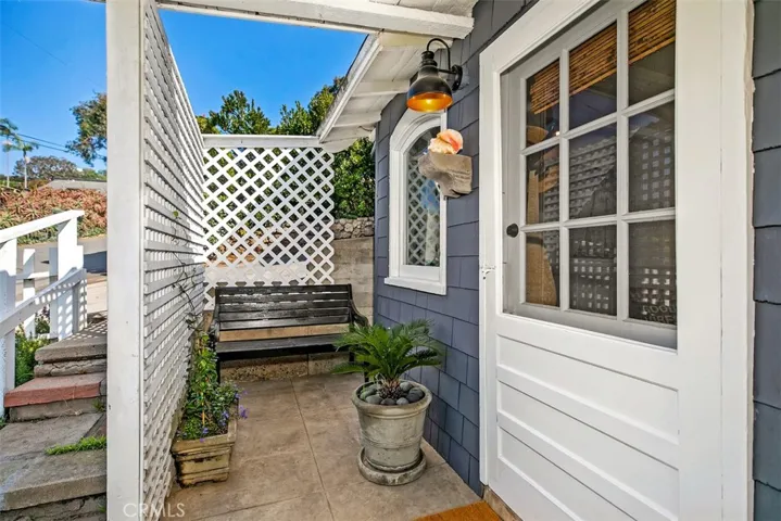 Front porch/patio area with stairs to the left coming from the driveway.