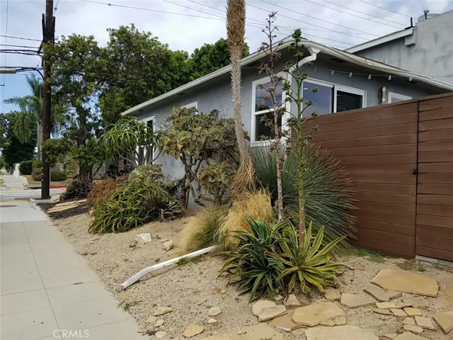 Low maintenance xeriscape with gate to private yard on right