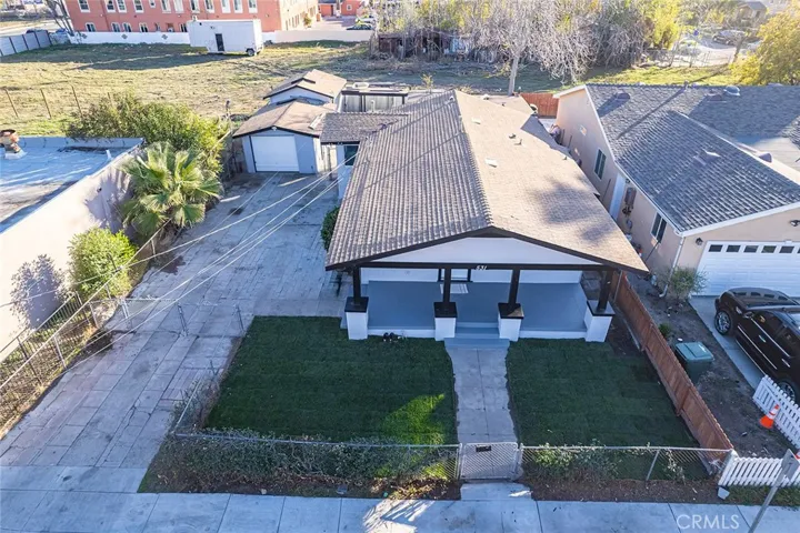 Aerial view of home and detached garage with rear workshop