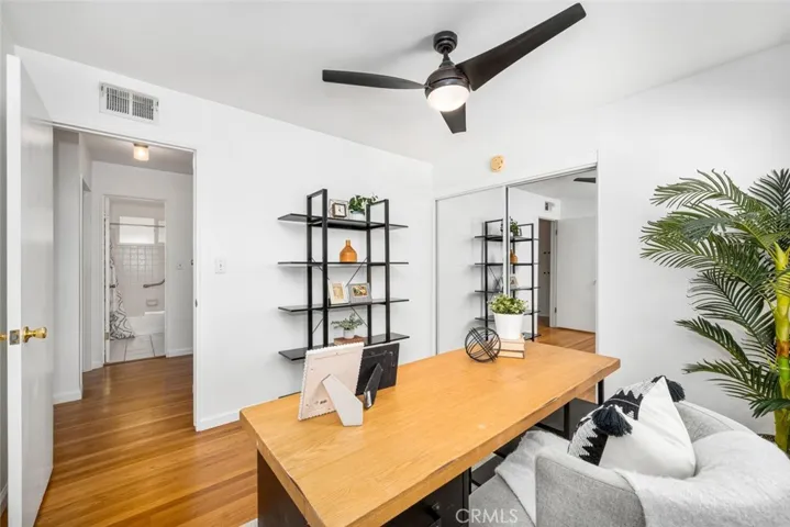 3rd bedroom with ceiling fan and hardwood flooring