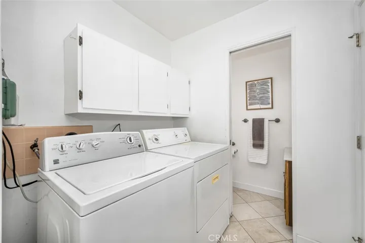 Laundry area adjacent to 1/2 bath and kitchen