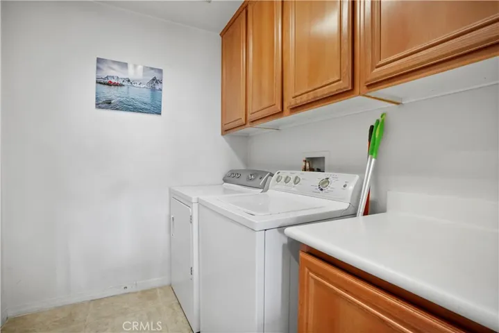 Downstairs: Large laundry room adjacent to 2 car garage and kitchen