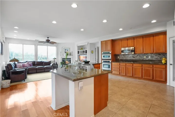 Downstairs: Ample kitchen with adjacent family room. There is direct access to the garage, and 2nd bonus room