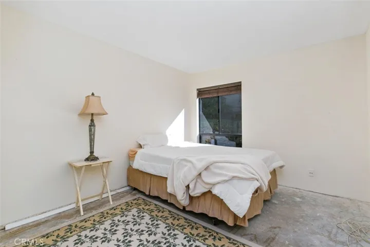 SPACIOUS SECONDARY BEDROOM. NEEDS CARPET AND COSMETIC REMODEL.