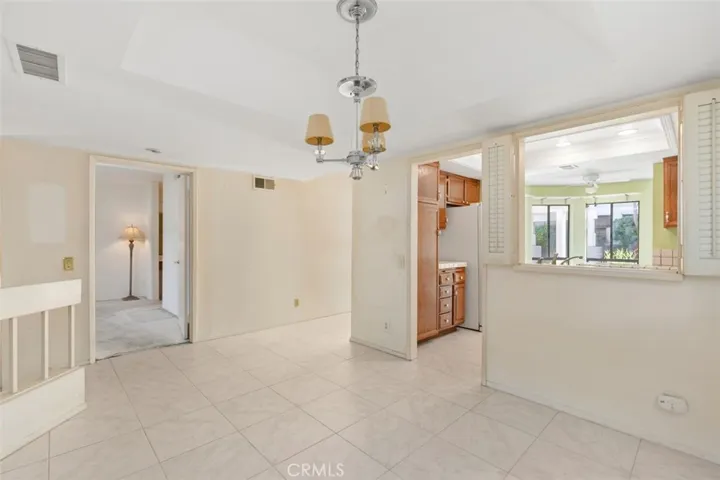 FORMAL DINING ROOM OPENS TO LIGHT AND BRIGHT KITCHEN.